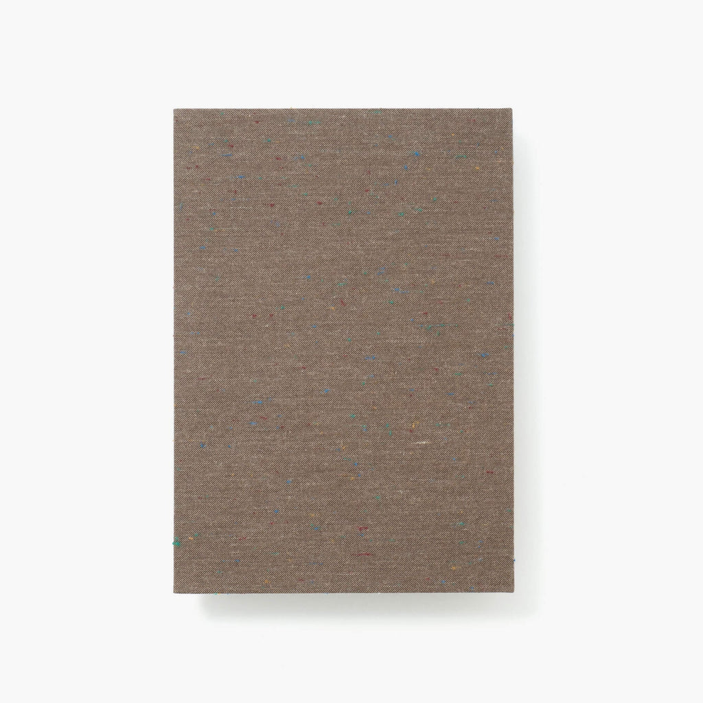 Kakimori A5 Notebook with Banshu-ori 04 speckled fabric cover, featuring light grey grid pages.