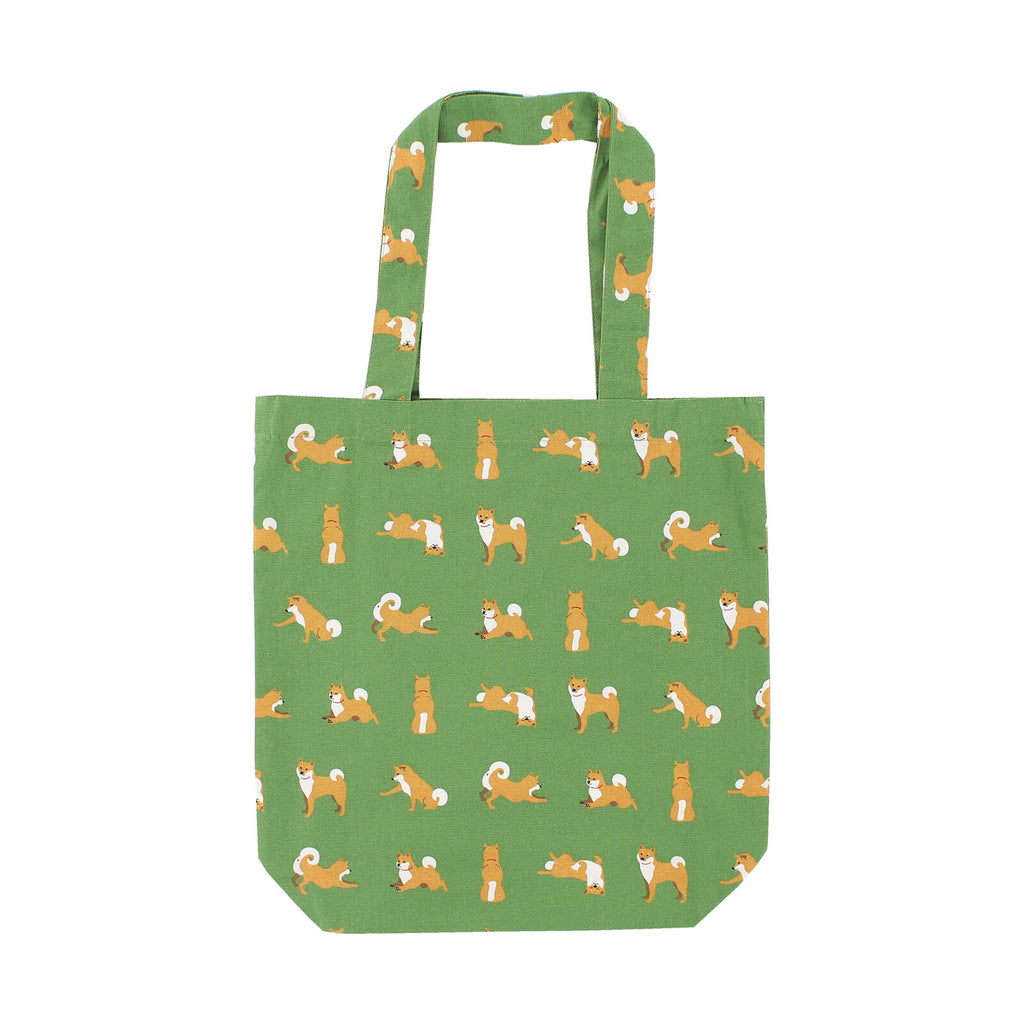 Green cotton tote bag adorned with playful Shiba Inu patterns, perfect for dog lovers and those who appreciate a touch of whimsy in their daily routine.