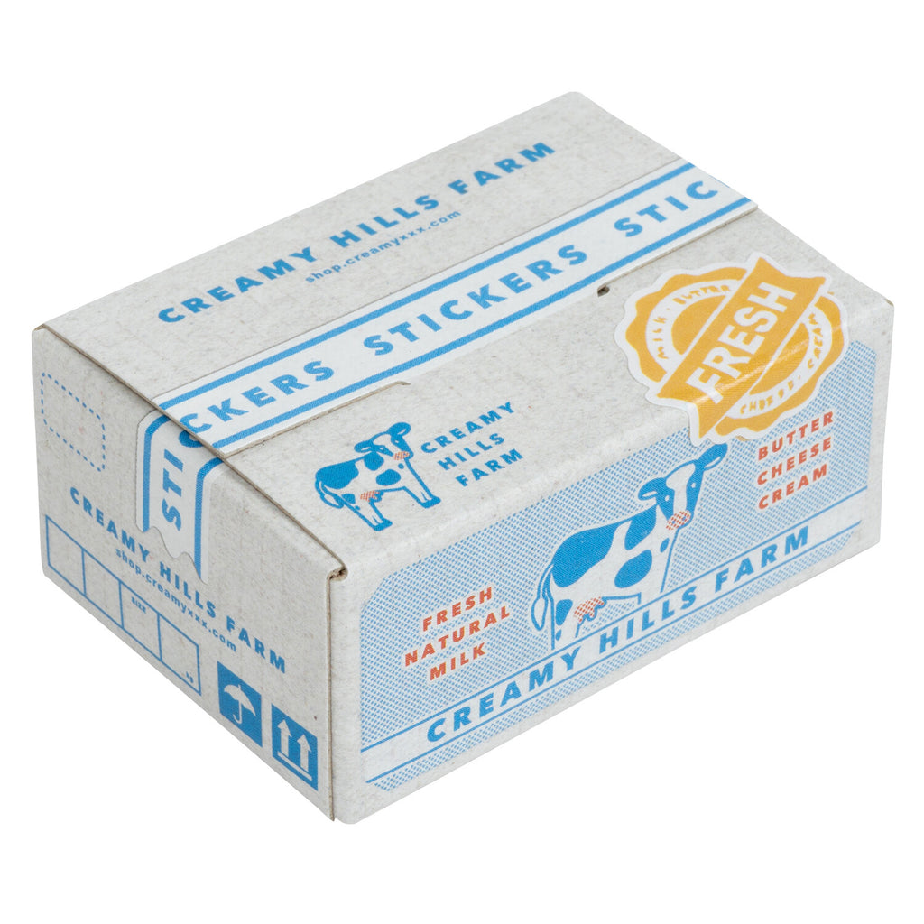 Compact box of Creamy Hills Farm holographic flake stickers with dairy-themed designs.
