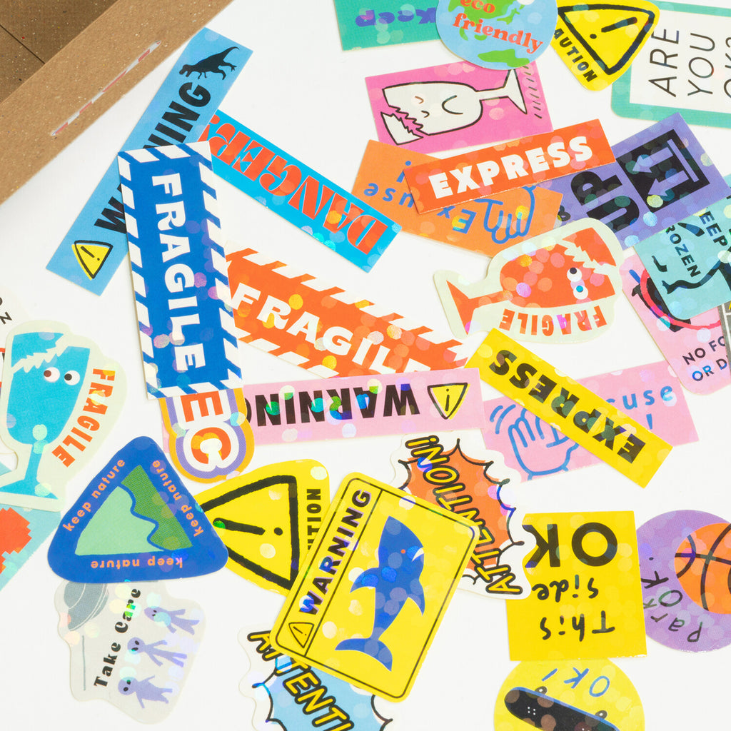 A colourful array of stickers with various fun warnings and playful messages displayed in an organised layout.