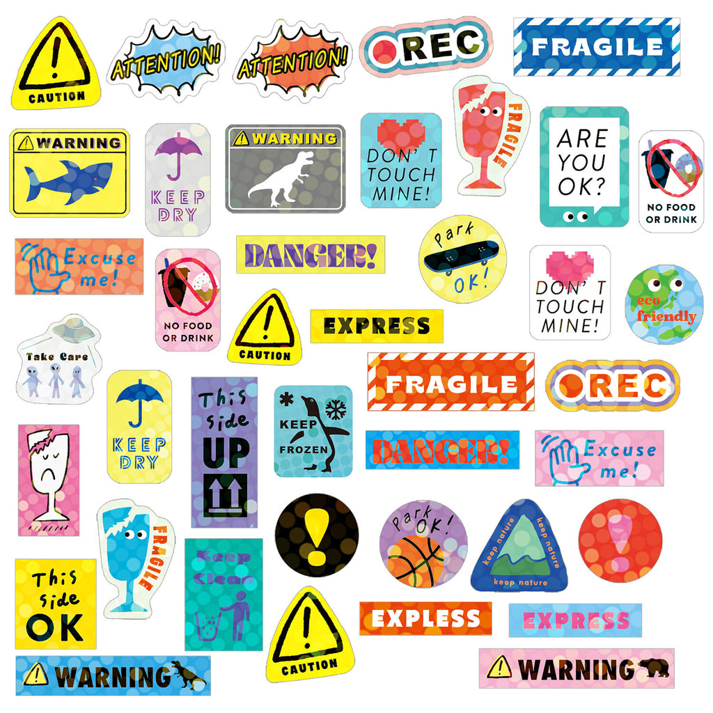 A spread of assorted stickers loosely arranged, showcasing the diversity of designs and the holographic sheen on some.