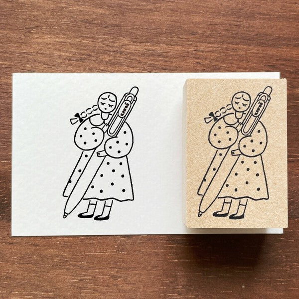 Rubber stamp with a design of a person playing a trombone on a wooden surface