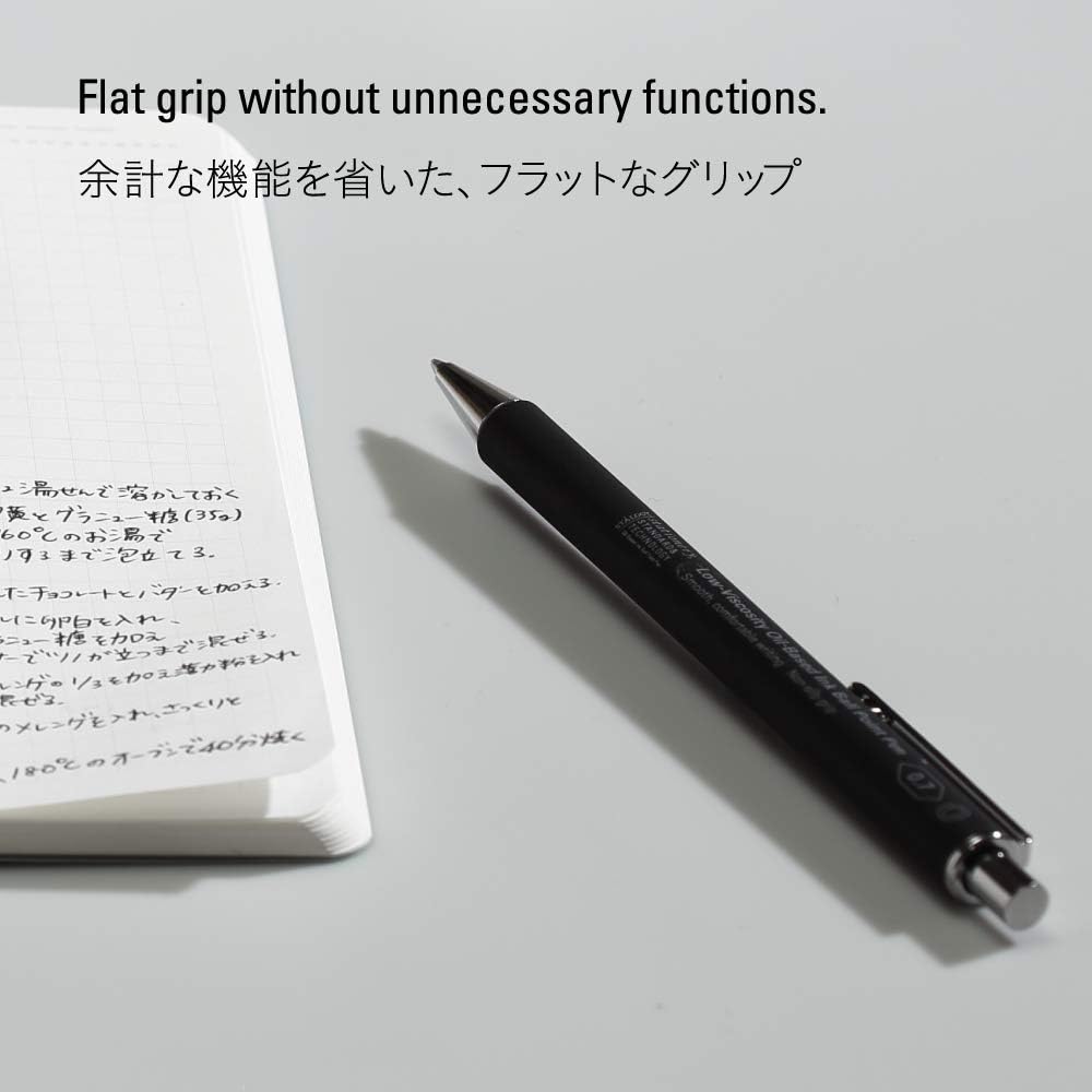 Stalogy pen positioned on a notebook page, emphasising its sleek design and functional simplicity.