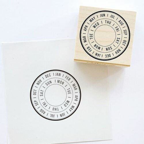 Wooden stamp featuring a circular calendar design with months and days, ideal for bullet journaling. Displayed on white paper. Measurements: 45 x 45 x 24mm.