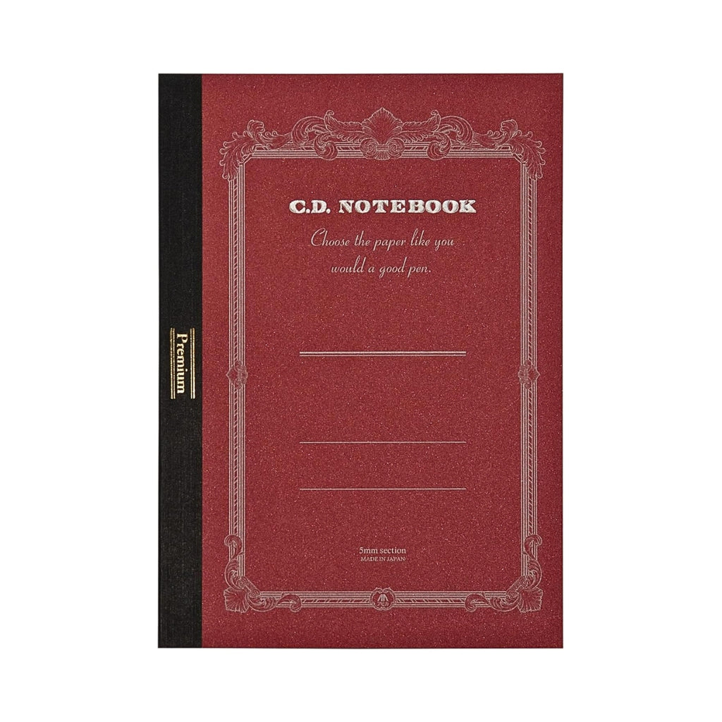 Apica Premium CD Notebook A5 Grid in deep red displayed upright with ornate silver-printed cover detailing.