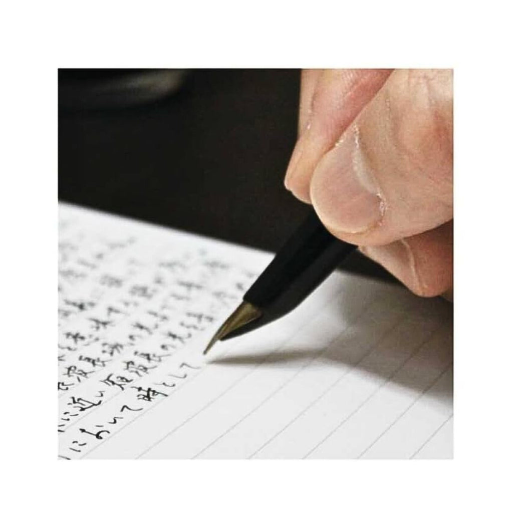Person writing in an Apica Premium C.D Notebook A6 Ruled with a black pen.