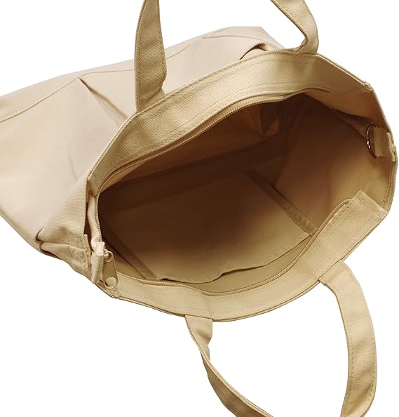 Wide open view of the beige canvas tote showing spacious interior and zip closure.