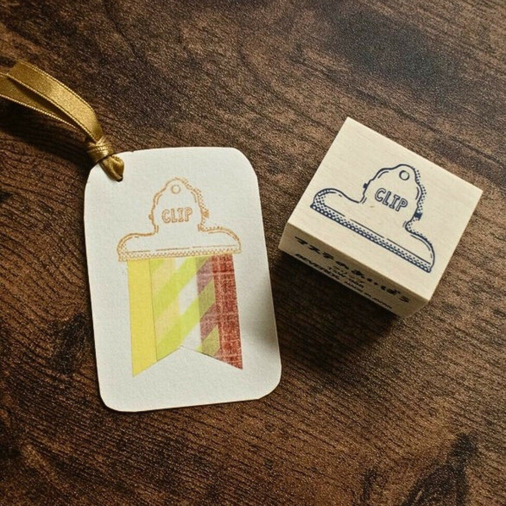 Beverly Masute No Aibo wooden clip stamp shown next to a decorated gift tag with stamped clip and washi tape.