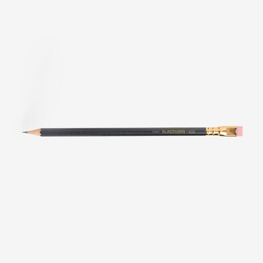 Single Blackwing 602 pencil shown horizontally with grey barrel, gold ferrule and pink eraser.