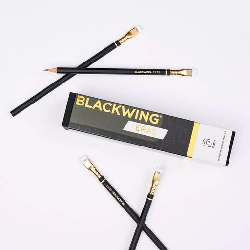 Pair of Blackwing Eras 2025 Edition pencils laid beside their packaging sleeve.