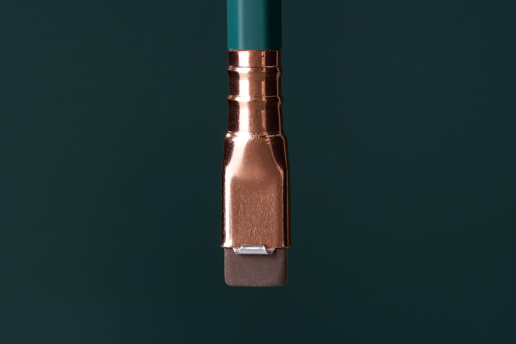Close-up of the gold ferrule and green barrel of a Blackwing Matte Green pencil.