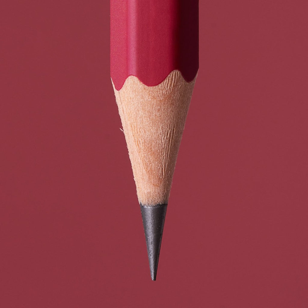 Close-up of the sharpened graphite point of a Blackwing Matte Red pencil.