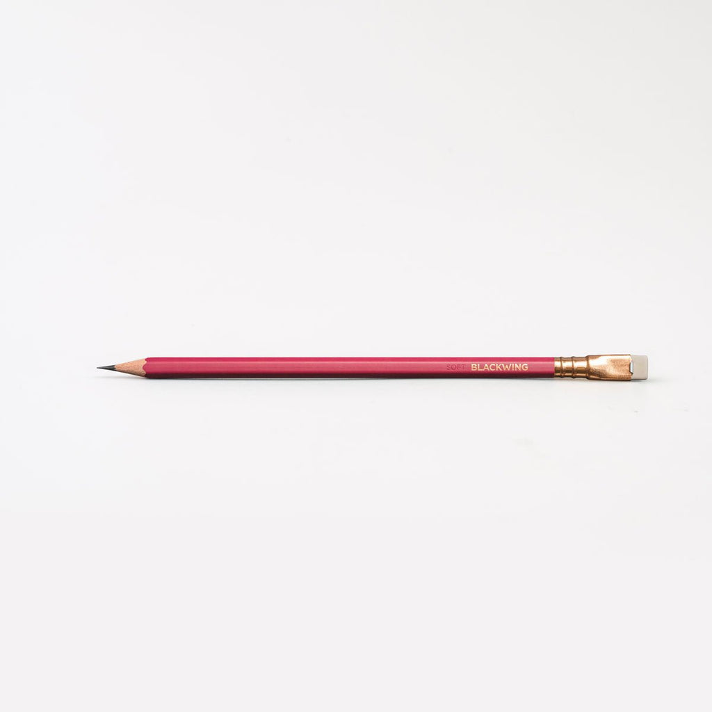 Single Blackwing Matte Red pencil shown horizontally with red barrel, gold ferrule and natural wood tip.