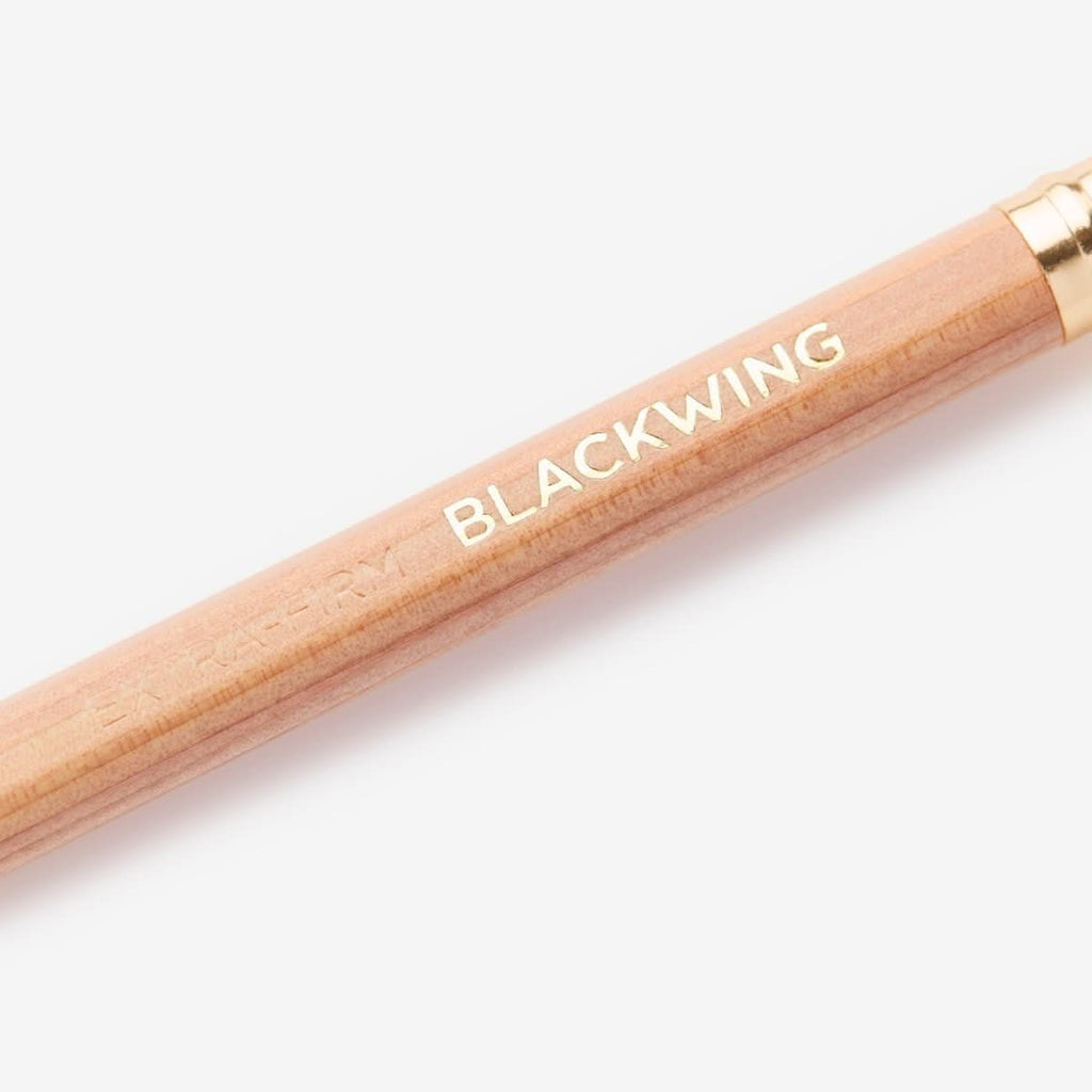Detail of the Blackwing Natural pencil barrel showing the natural wood finish and printed logo.