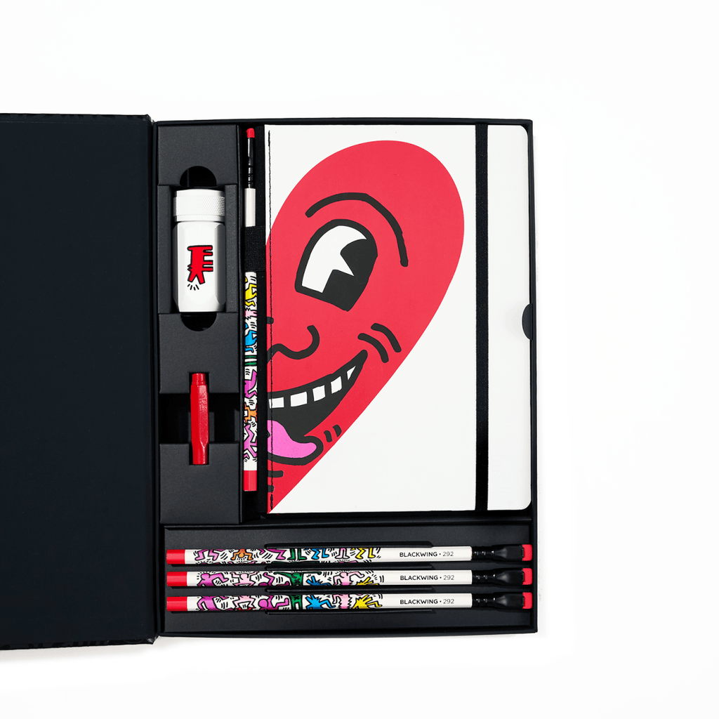 The Journal Shop - Blackwing Volume 292 Gift Set Keith Haring Smiling Heart edition open box with pencils, notebook and eraser.