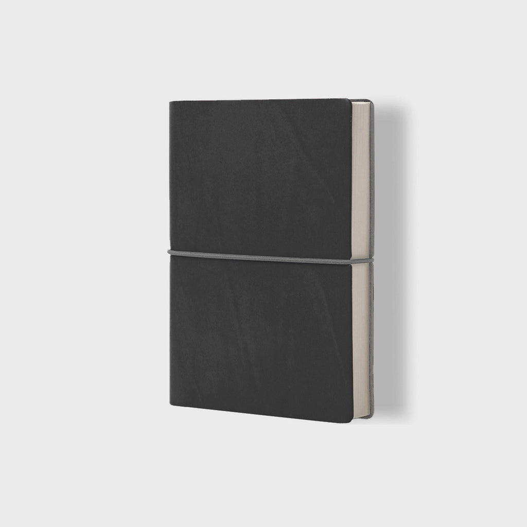 CIAK A5 Daily Planner 2024 with its eco-leather cover and signature horizontal elastic band, displaying a day-per-page layout.