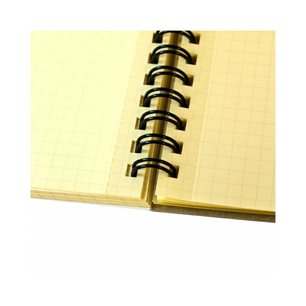 Detailed close-up of Rollbahn notebook showing squared cream pages and black spiral binding.