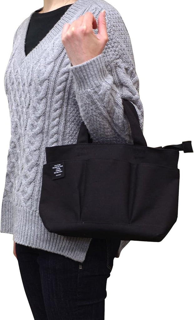 Lifestyle image of a person carrying the Delfonics Rollbahn Small Inner Bag, highlighting its compact size and stylish design.