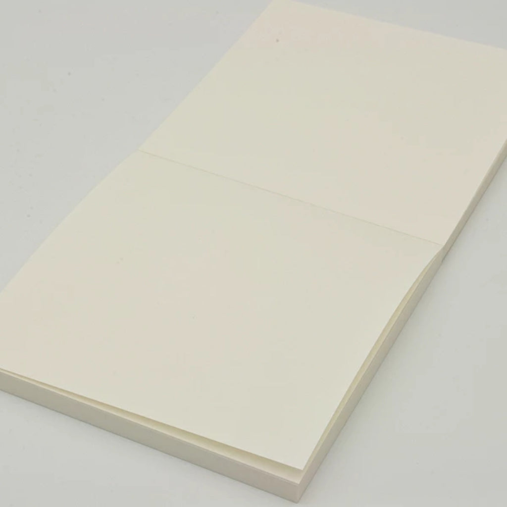 GRAPHiLO note pad with one sheet lifted, revealing plain cream paper.
