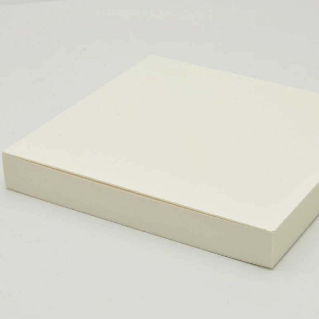 Side view of GRAPHiLO note pad highlighting paper thickness and block shape.
