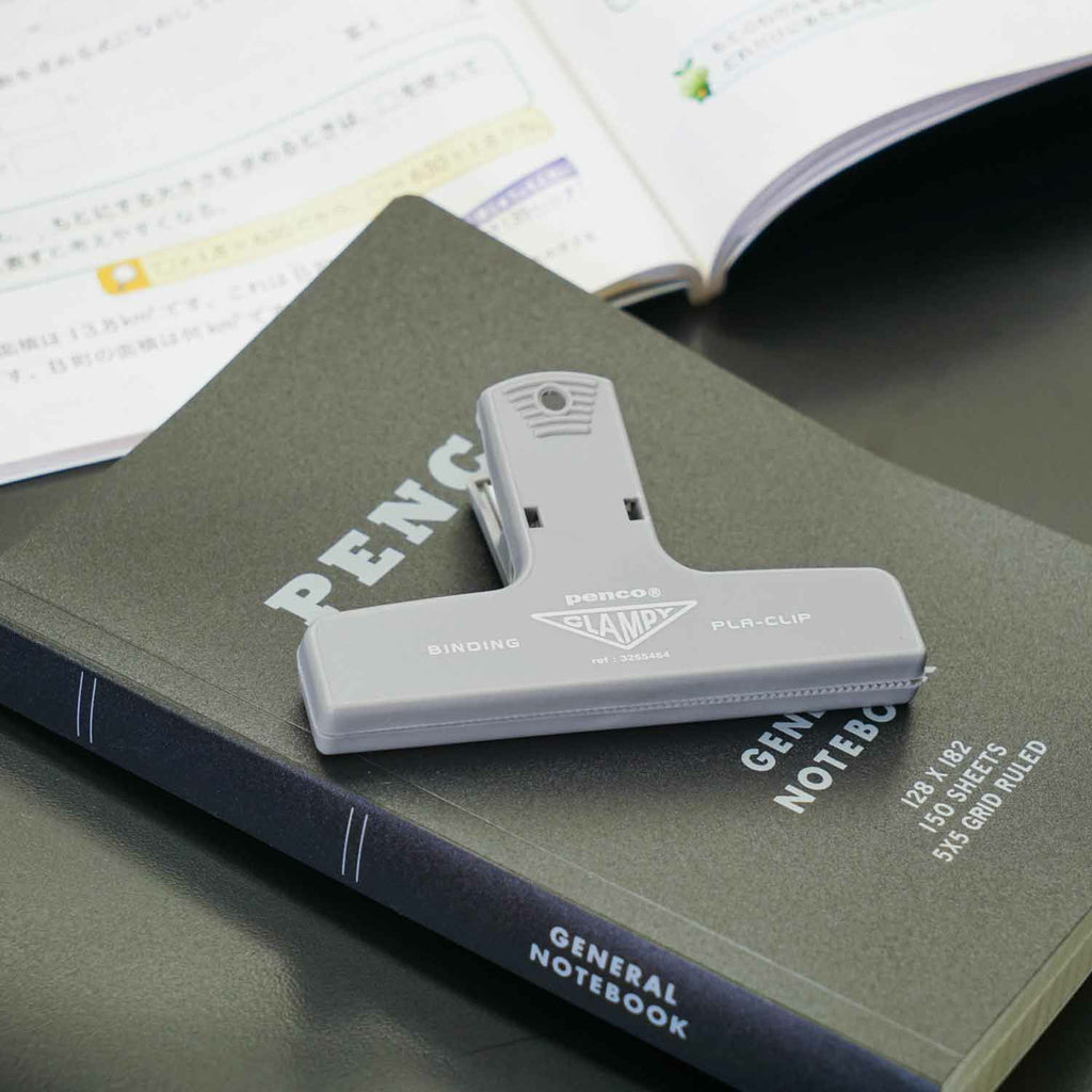 The Journal Shop - Grey Hightide Penco Clampy Pla-Clip displayed over the notebook.