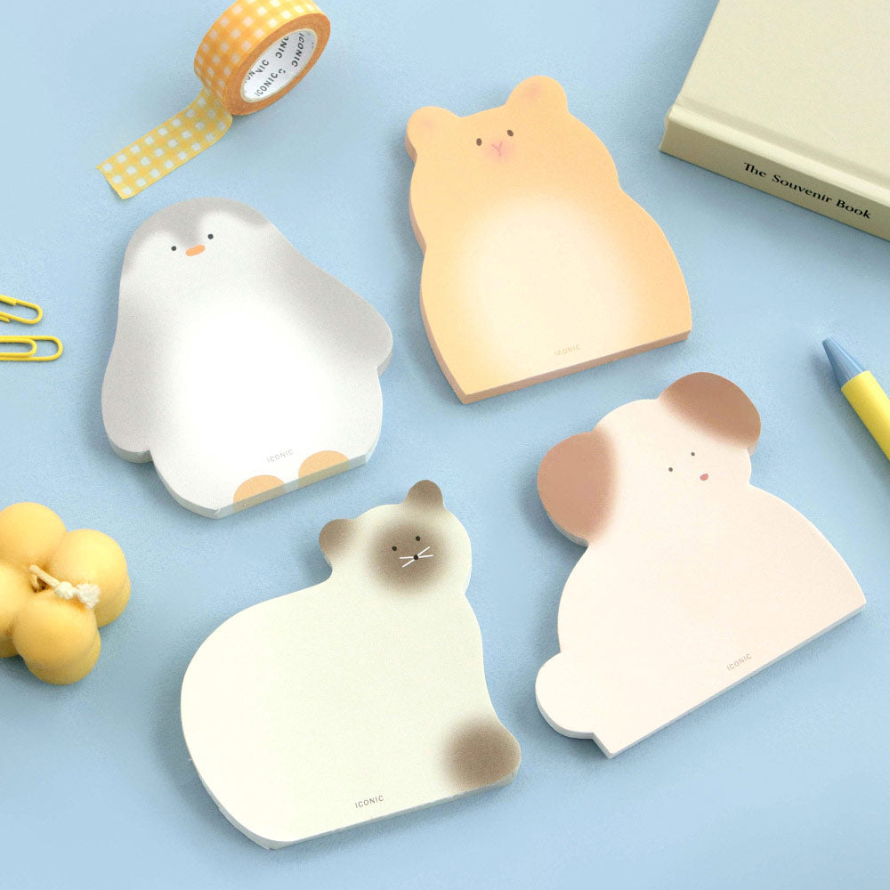 The Journal Shop - A set of Iconic Animal Memo Pads shaped like cute animals, including a penguin, cat, and dog, displayed on a light blue background with stationery.