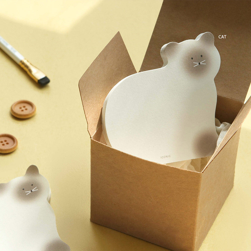 The Journal Shop - A white brown cat-shaped Iconic Animal Memo Pad placed inside a small box with stationery around it.