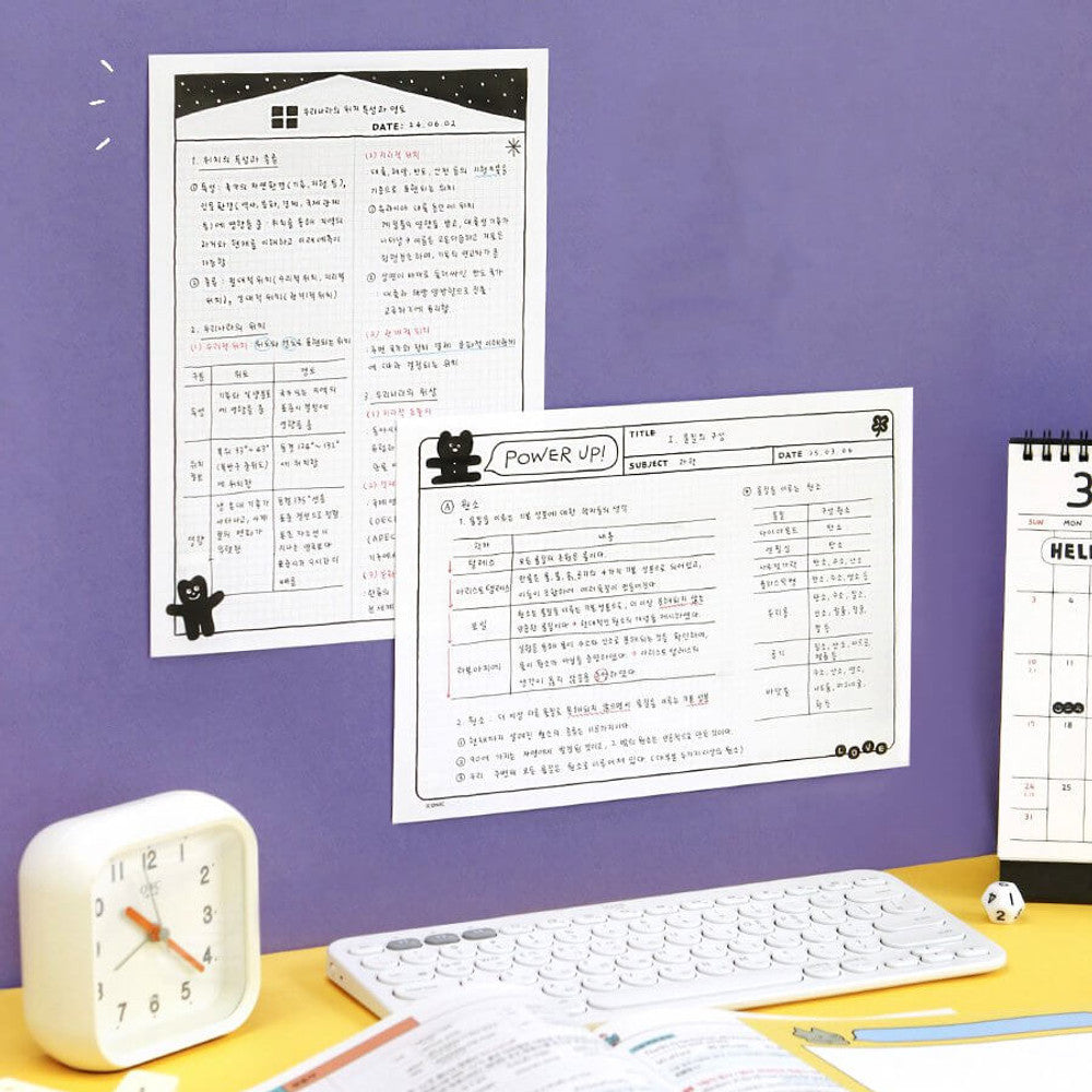 The Journal Shop - Iconic Doodle B5 Grid Notepad black cover version open showing squared grid layout.