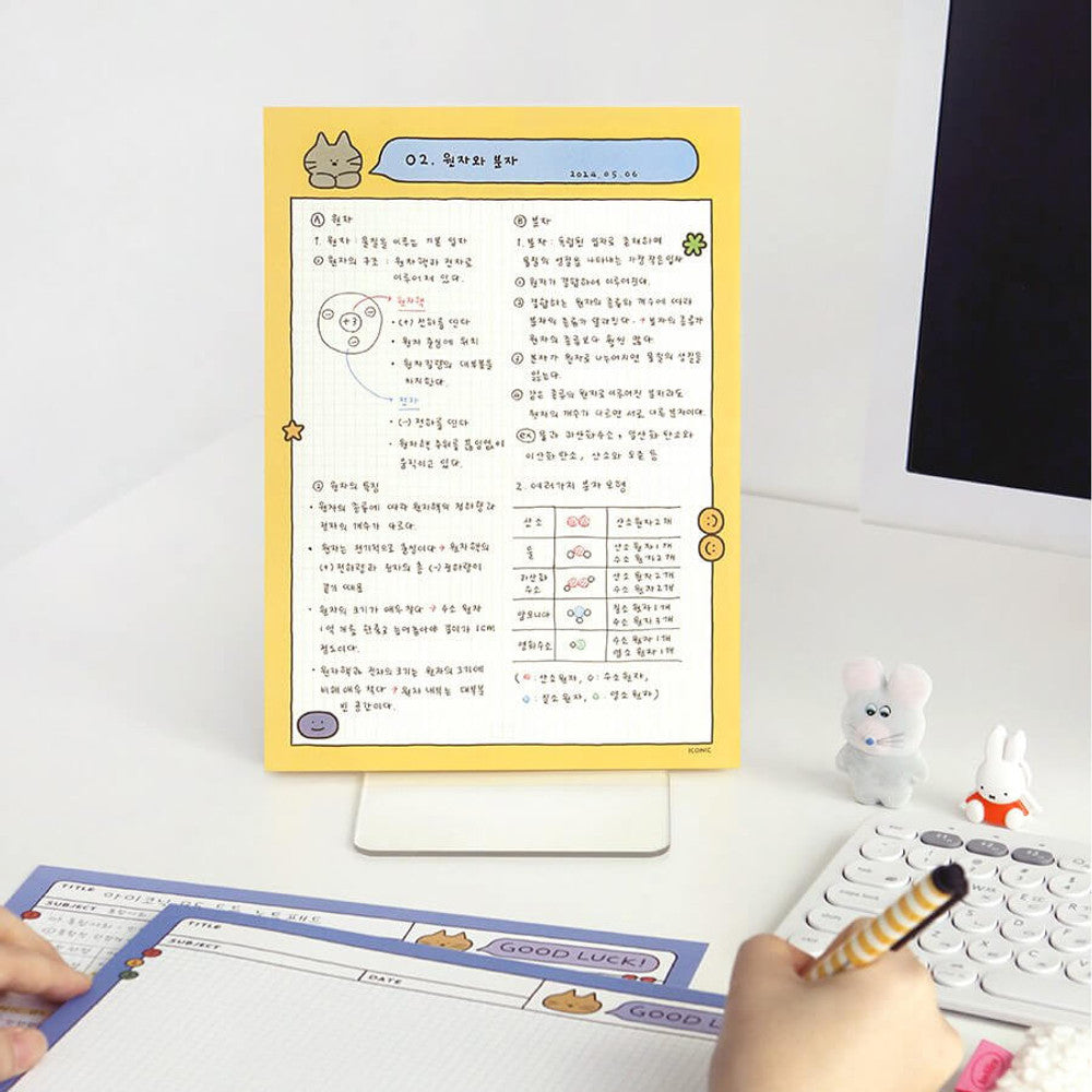 The Journal Shop - Iconic Doodle B5 Grid Notepad set in yellow and black displayed together with stationery accessories.