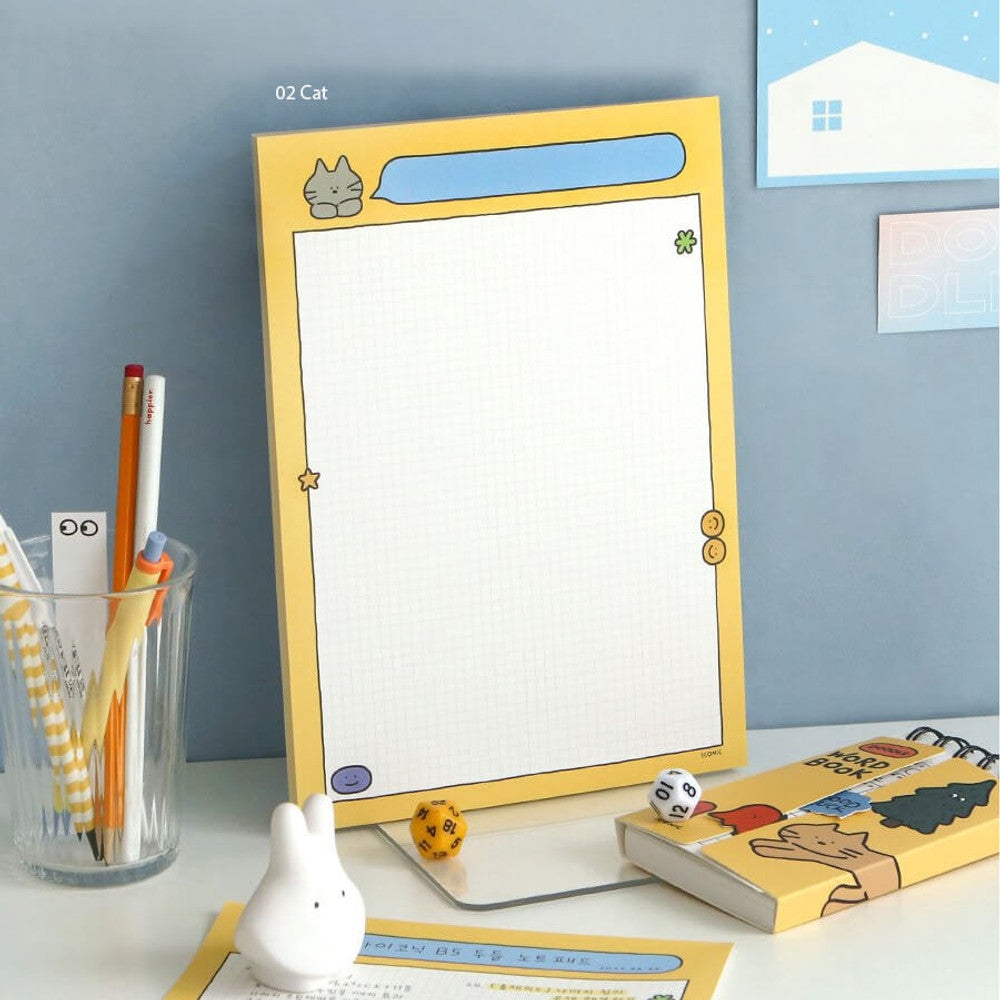 The Journal Shop - iconic doodle B5 grid notepad with cat design in yellow color.