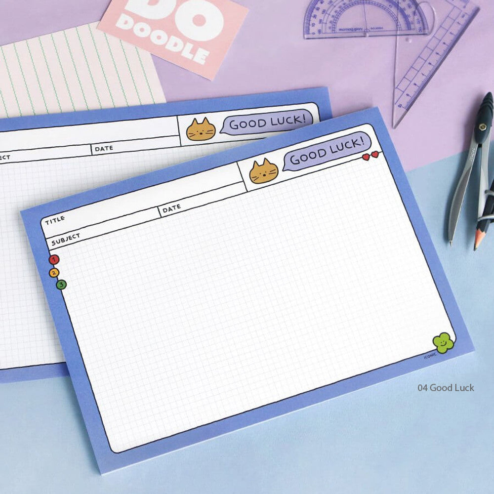 The Journal Shop - Iconic Doodle B5 Grid Notepad blue version on desk with pencil and rulers.