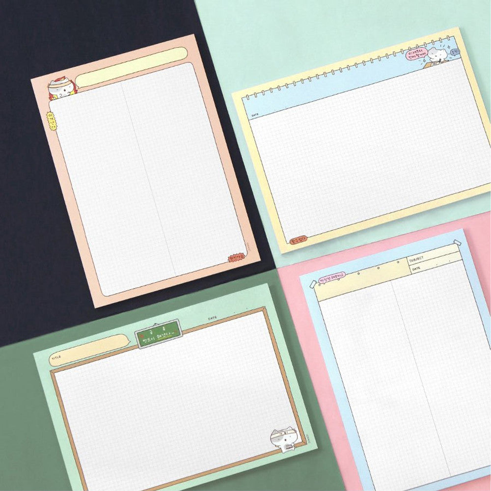 The Journal Shop - Iconic Blah Blah B5 Memo Notepads in pastel green, blue, and yellow displayed flat on black background.