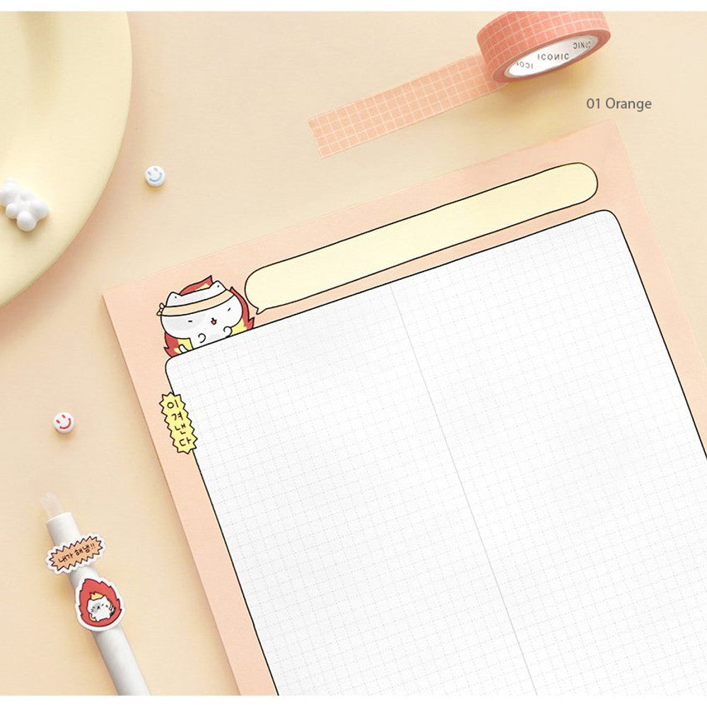 The Journal Shop - Iconic Blah Blah B5 Memo Notepad pastel orange version open on light desk with pen and candle.