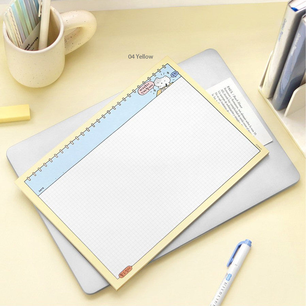 The Journal Shop - Iconic Blah Blah B5 Memo Notepad pastel yellow version with handwritten notes beside cup and pen.