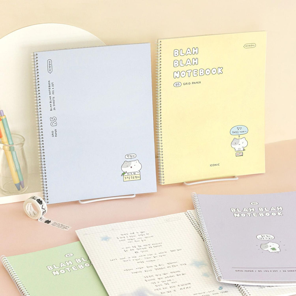 The Journal Shop - Iconic Blah Blah B5 Spiral Grid Notebooks in blue and green covers displayed beside matching stationery.