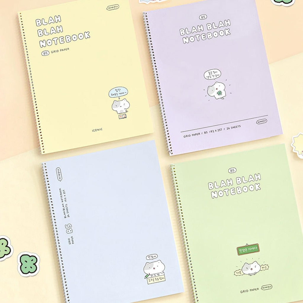 The Journal Shop - Iconic Blah Blah B5 Spiral Grid Notebooks in yellow and lavender covers displayed together on pastel background.