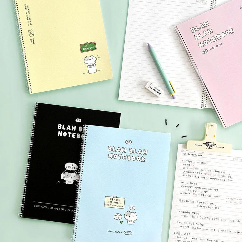 The Journal Shop - Iconic Blah Blah B5 Spiral Lined Notebooks in pastel yellow and blue displayed together on light background.