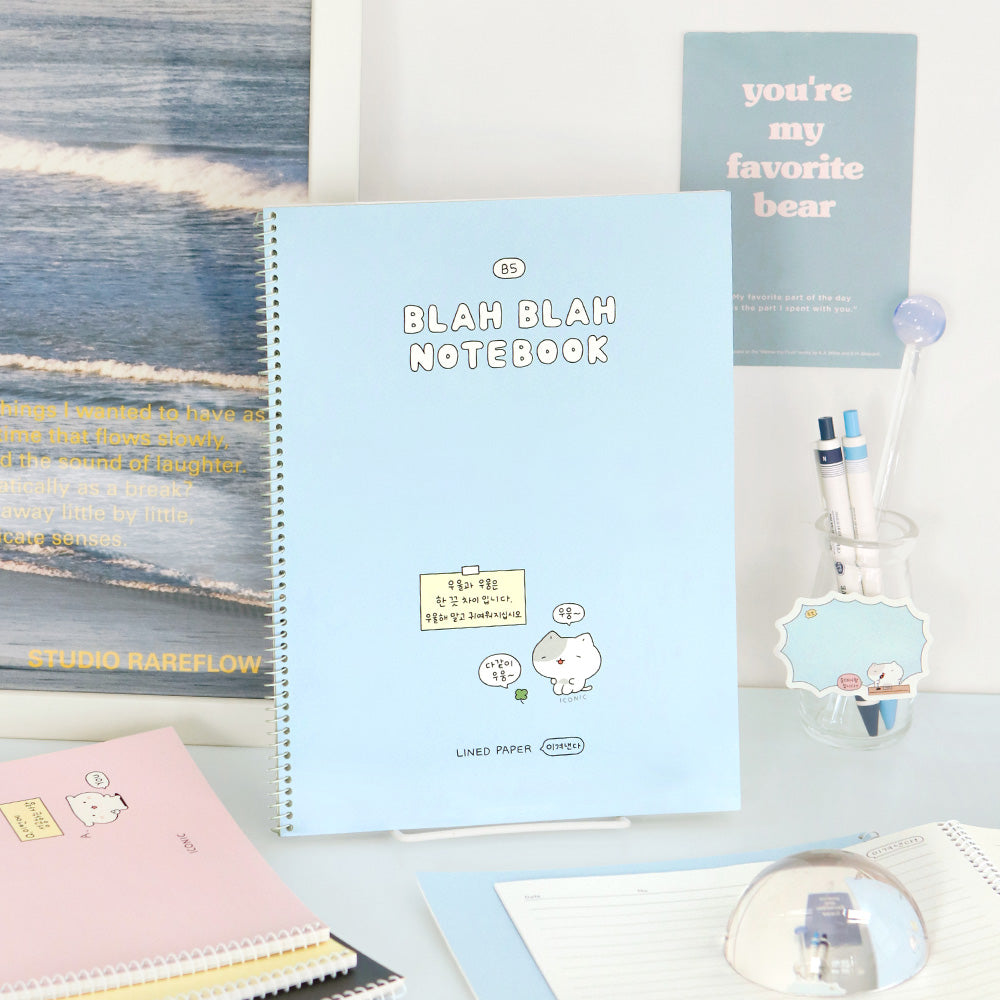 The Journal Shop - Iconic Blah Blah B5 Spiral Lined Notebook pastel blue cover open beside matching stationery items.