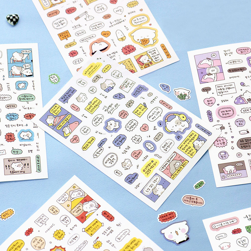 The Journal Shop - Assorted sheets of Iconic Blah Blah Daily Stickers laid out on a blue surface showing various cheerful designs.