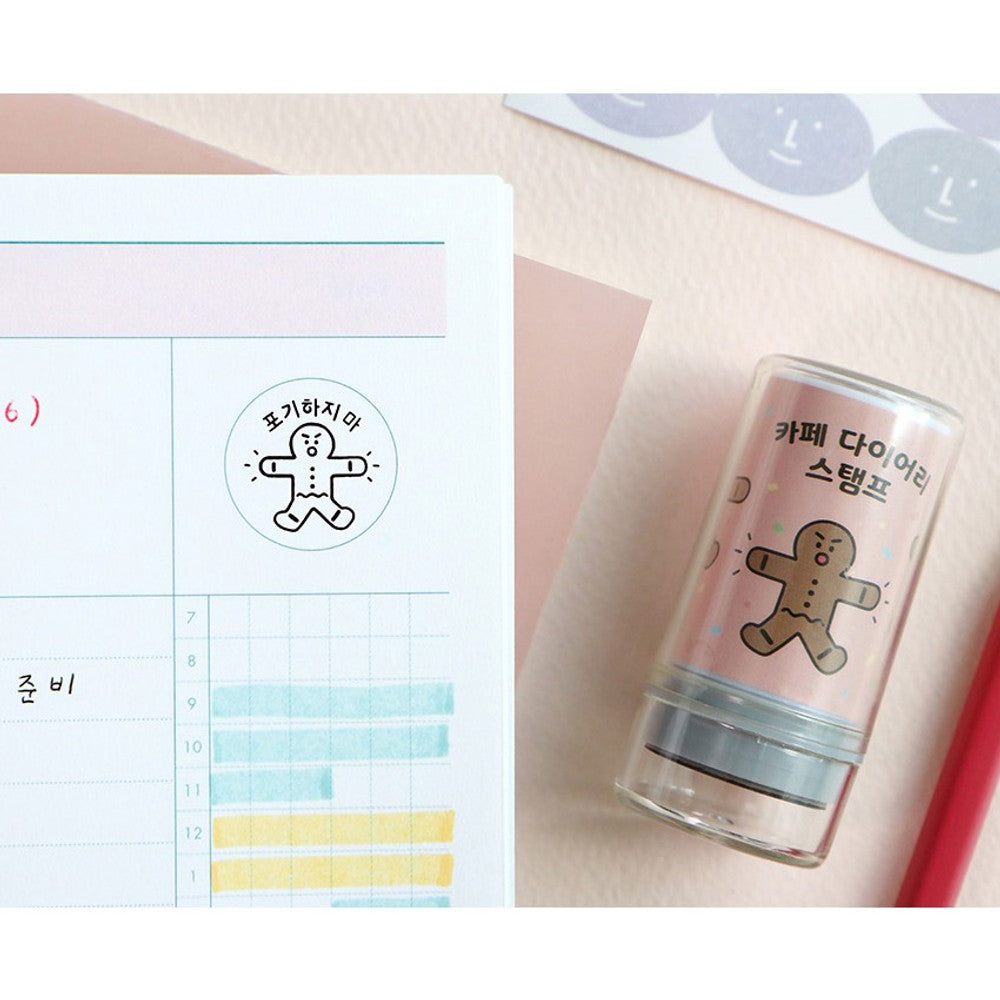 The Journal Shop - Planner page decorated with café-themed stamps and colourful writing beside an open diary.