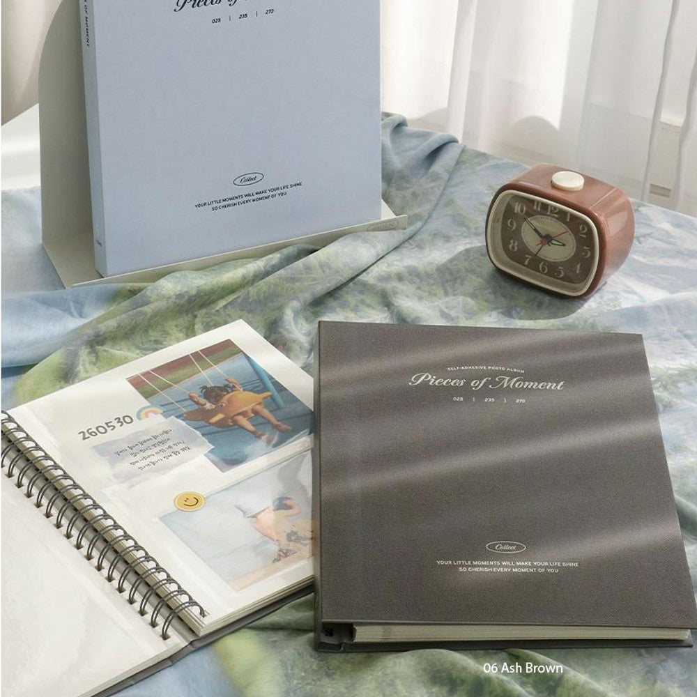 The Journal Shop - Iconic Collect Self-Adhesive Photo Album 25 sheets in white and ash brown covers displayed together with photos.