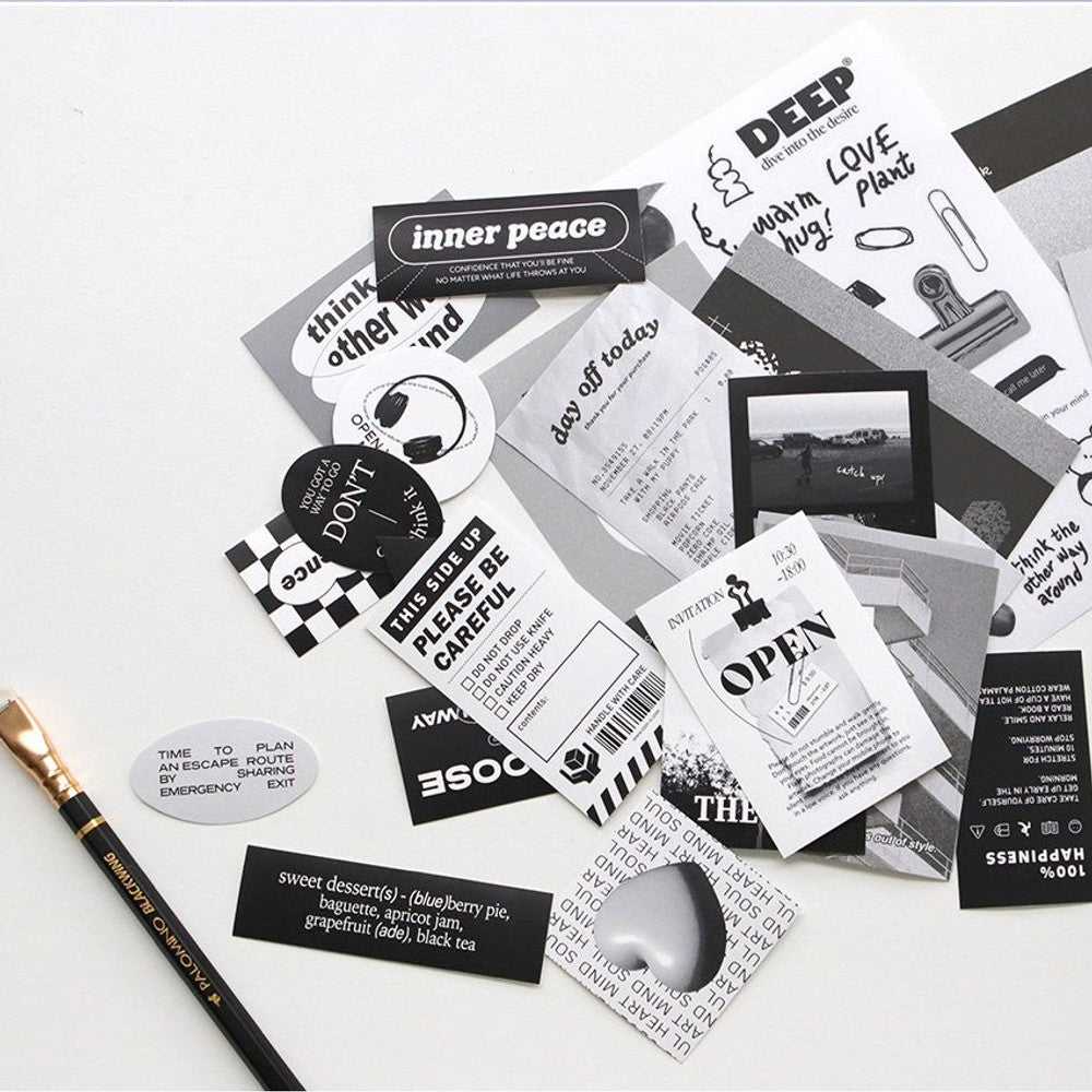 The Journal Shop - Selection of monochrome and patterned stickers spread out beside stationery.