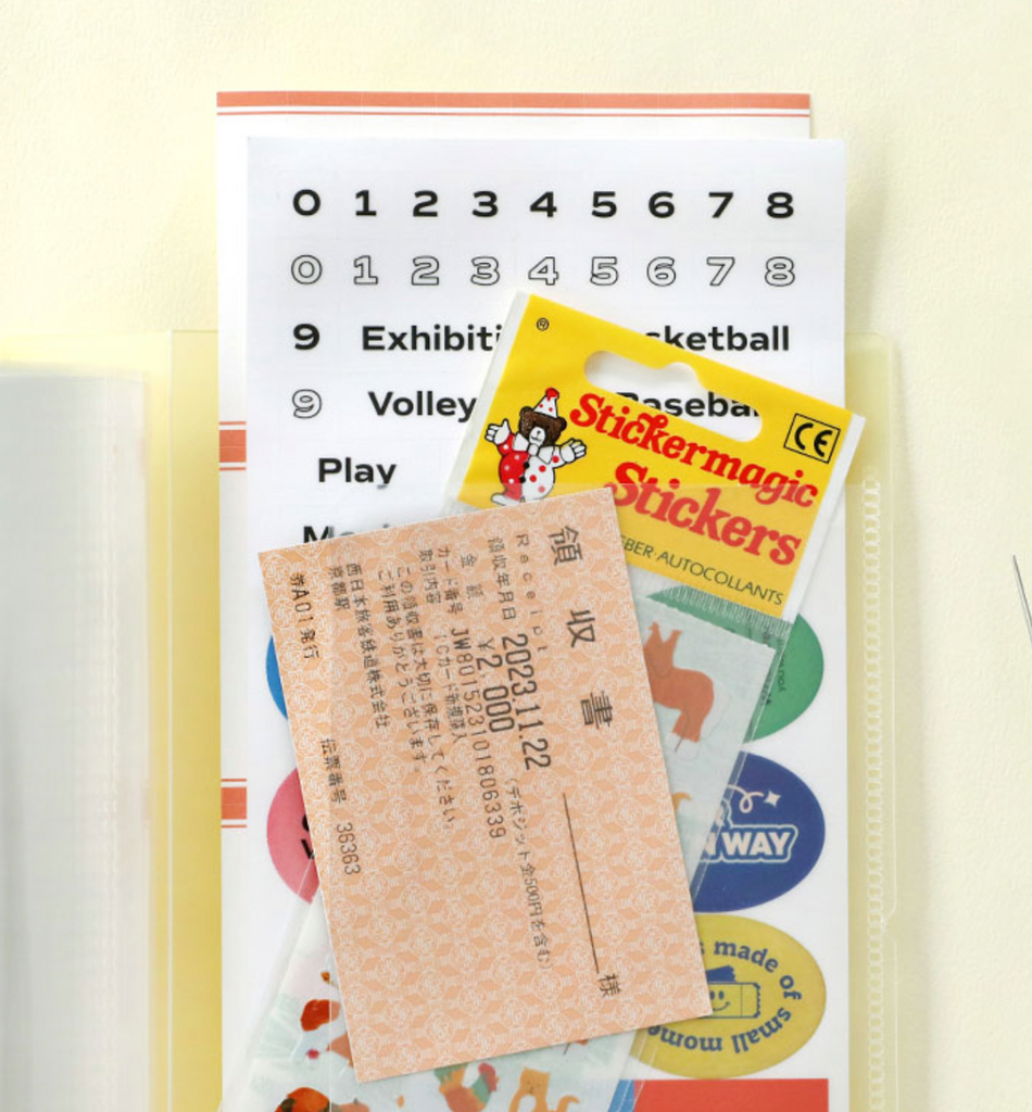 The Journal shop - Iconic Collect Ticket Book 64 pockets in cream yellow with tickets stored inside.