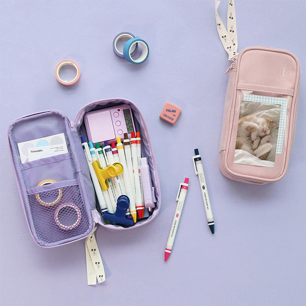The Journal Shop - Open lavender and pink pen pouches filled with pens, sticker, and washi tapes.