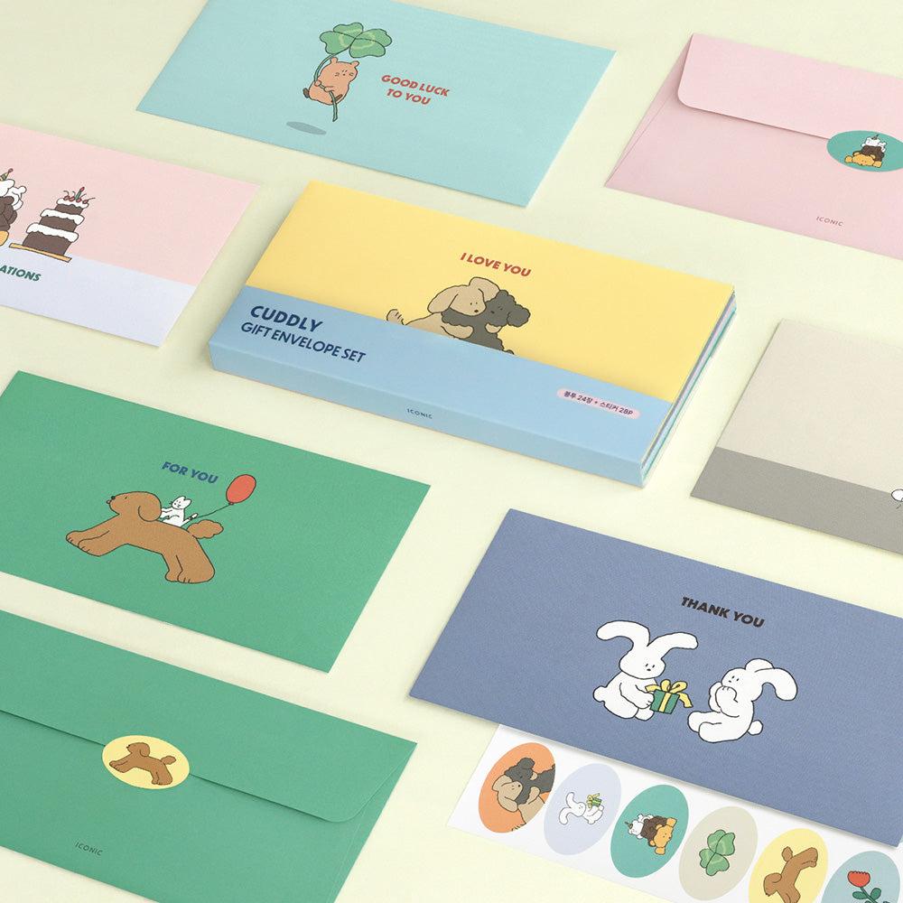 The Journal Shop - Collection of Iconic Cuddly Envelopes in assorted colours with cute animal illustrations and matching stickers laid out on a light desk.