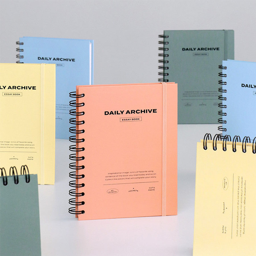 The Journal Shop - Assorted colours of the Iconic Daily Archiving Spiral Book displayed upright and flat, showing the stylish and minimal cover designs.