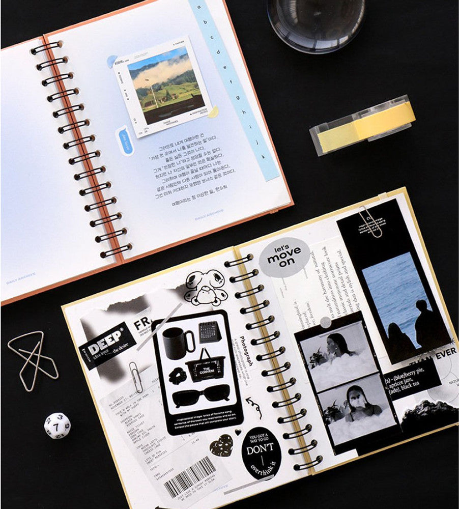 Overhead view of a peach coral and custard Iconic Daily Archiving Spiral Book used for photo archiving and journaling, featuring neatly arranged layouts.