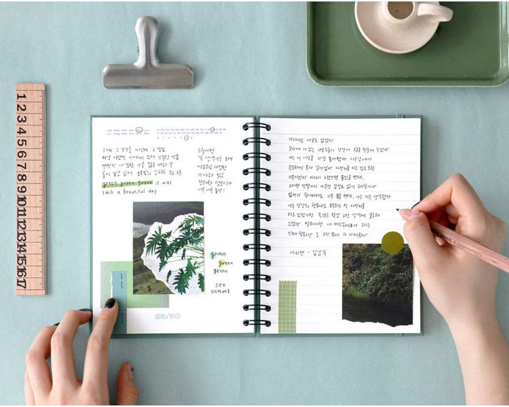 Person using the Iconic Daily Archiving Spiral Book at a desk, highlighting its practicality for everyday writing or memory-keeping.