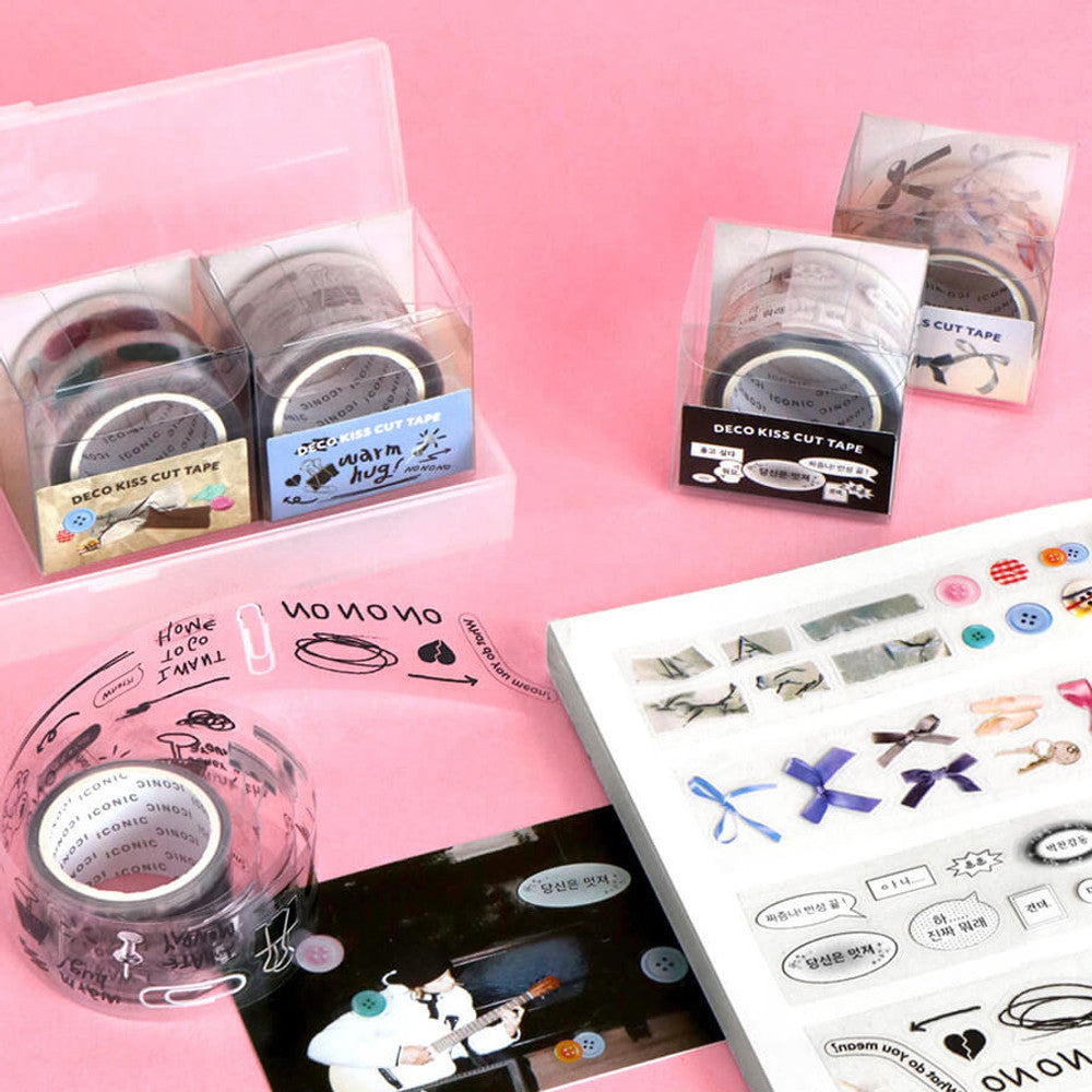 The Journal Shop - Iconic Deco Kiss-Cut Tape in different styles displayed on a pink background, featuring packaging and unrolled tape samples.