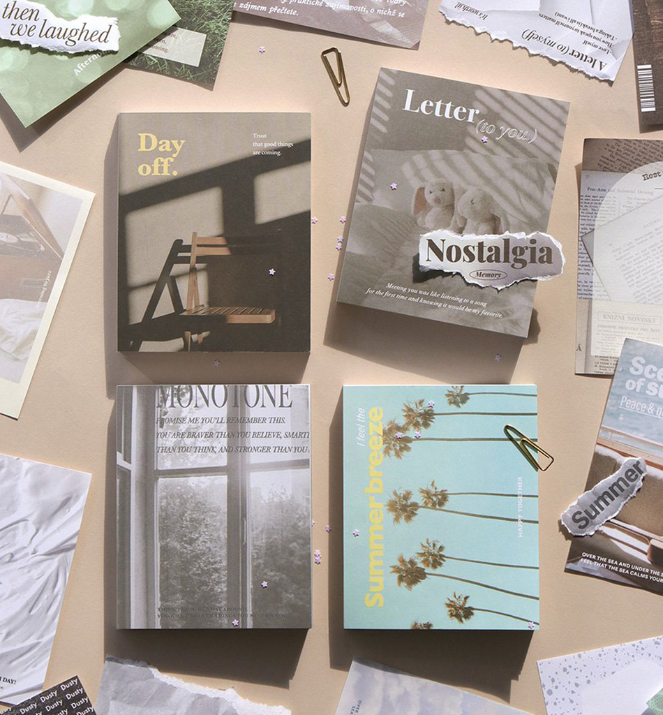 The Journal Shop - Collection of Iconic Deco Memo Pads in various nostalgic designs laid out on a beige desk.